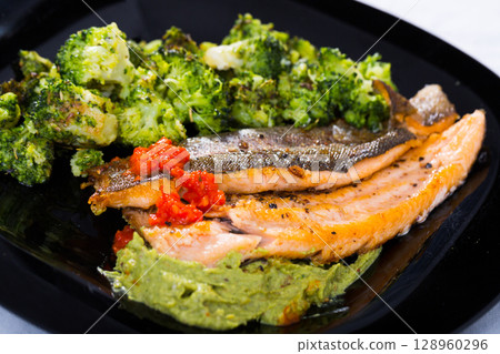 Fried trout with broccoli and sauces Fried trout with broccoli and sauces 128960296