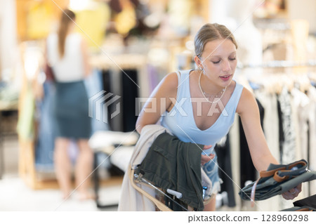 Woman shopping in a boutique Woman shopping in a boutique 128960298