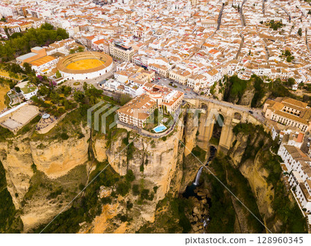 Rocky landscape of Ronda with buildings and Bridge, Andalusia, Spain 128960345