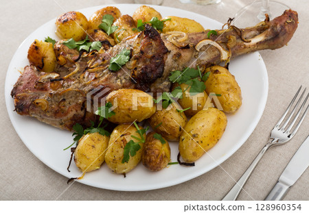 Lamb shoulder baked with new potatoes Lamb shoulder baked with new potatoes 128960354