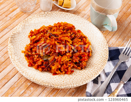 Stewed cabbage with pearl barley on wooden table Stewed cabbage with pearl barley on wooden table 128960465