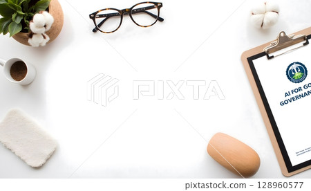 Workspace with a clipboard, glasses, coffee, and plant on a minimalist desk with blank space 128960577