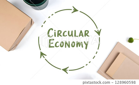 Circular Economy Concept with Eco-Friendly Elements and Cardboard Packaging on Clean Surface Circular Economy Concept with Eco-Friendly Elements and Cardboard Packaging on Clean Surface 128960598