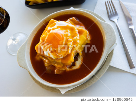 Typical portuguese sandwich like croque monsieur called Francesinha with cheese and steak Typical portuguese sandwich like croque monsieur called Francesinha with cheese and steak 128960845