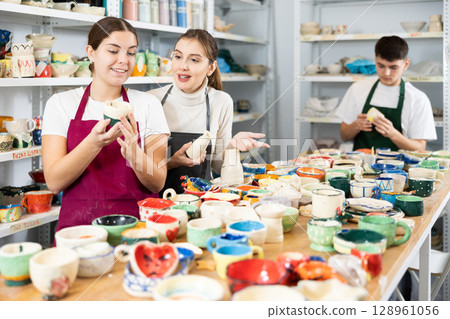Man and women viewing handmade clay products Man and women viewing handmade clay products 128961056