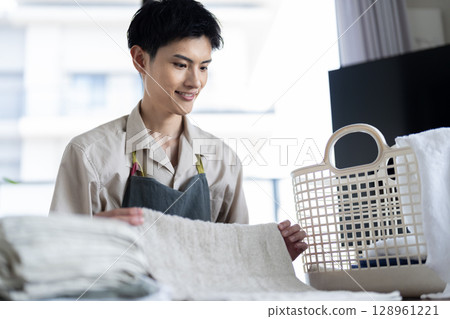 Men who fold laundry Men who fold laundry 128961221