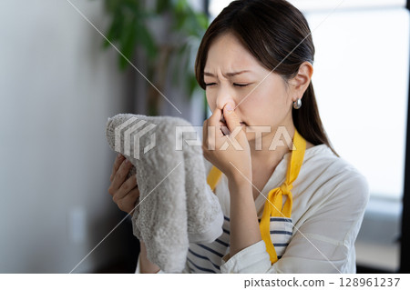 A housewife checking the smell of laundry A housewife checking the smell of laundry 128961237