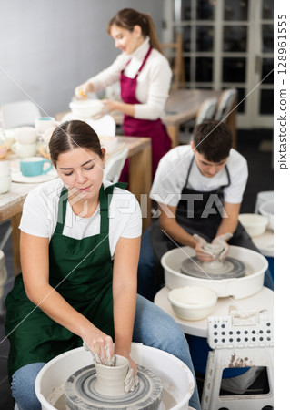 Woman working with pottery wheel 128961555