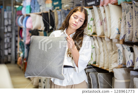 Woman choosing pillow in home textile shop Woman choosing pillow in home textile shop 128961773