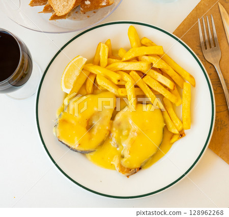 Stewed hake Merluza en salsa holandesa with potatoes 128962268