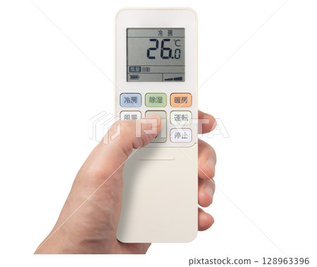 Hand operating the air conditioner remote control Hand operating the air conditioner remote control 128963396