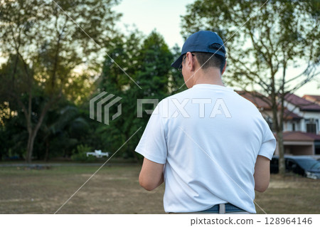Man operating drone in the field 128964146