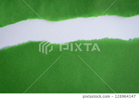 Torn green paper into half on top of white background 128964147