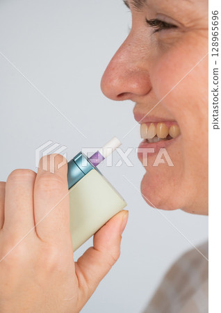 Caucasian woman smoking electronic cigarette. Tobacco heating system. Caucasian woman smoking electronic cigarette. Tobacco heating system. 128965696