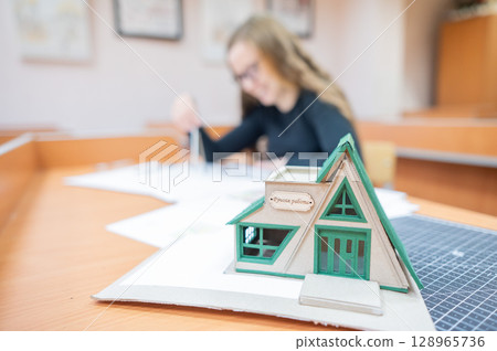 Caucasian young woman making drawings. Student of architecture university.  128965736