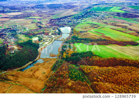 Aerial view of autumn Stradch village, church of Assumption of Blessed Virgin Mary, lake and pine forests in Ukraine Aerial view of autumn Stradch village, church of Assumption of Blessed Virgin Mary, lake and pine forests in Ukraine 128965739