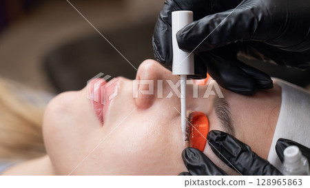 Caucasian woman undergoing eyelash lamination procedure.  128965863