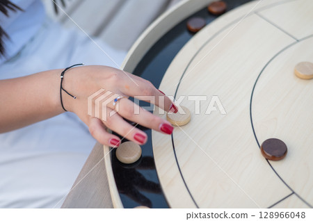 Strategic Game Pieces on a Wooden Board crokinole.  128966048