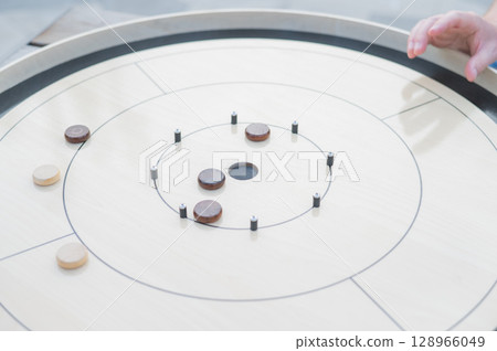 Strategic Game Pieces on a Wooden Board crokinole.  128966049
