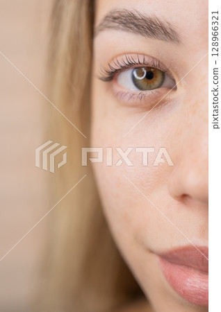 Close-up of a woman's eye after eyelash lamination procedure. Close-up of a woman's eye after eyelash lamination procedure. 128966321