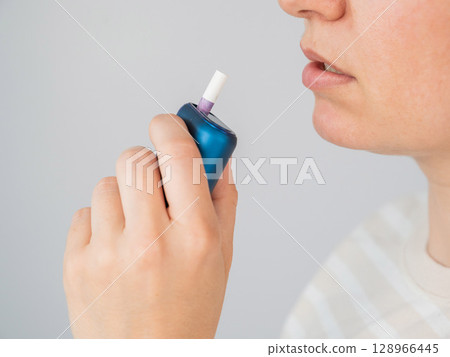Caucasian woman smoking electronic cigarette. Tobacco heating system. Caucasian woman smoking electronic cigarette. Tobacco heating system. 128966445