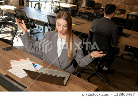 Cute long-haired blonde female manager working in the office 128966487