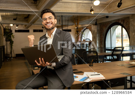 Young good-looking young manager feeling positive while working in the office 128966584