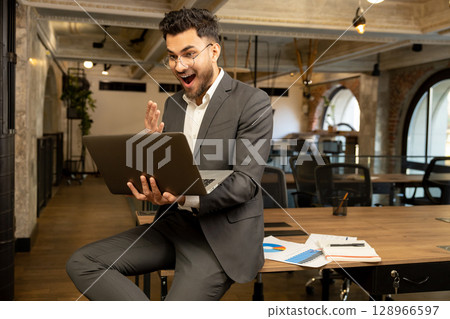 Young manager looking excited after receiving a good news 128966597