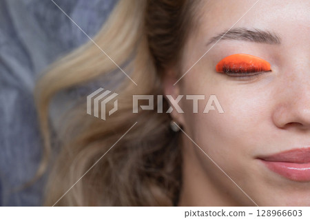 Caucasian woman undergoing eyelash lamination procedure. Top view. Caucasian woman undergoing eyelash lamination procedure. Top view. 128966603