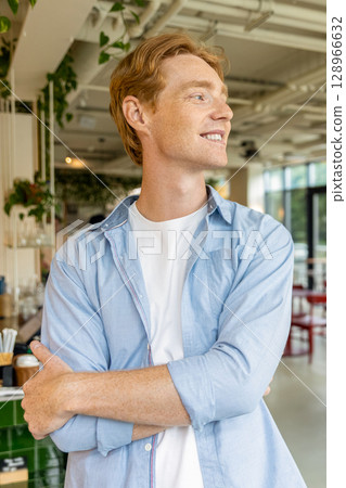 Ginger handsome young guy looking confident and positive Ginger handsome young guy looking confident and positive 128966632