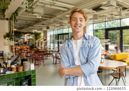 Ginger handsome young guy looking confident and positive Ginger handsome young guy looking confident and positive 128966635