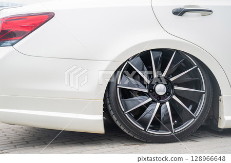 Close-Up of Custom Car Wheel and Tire Excellence. Close-Up of Custom Car Wheel and Tire Excellence. 128966648