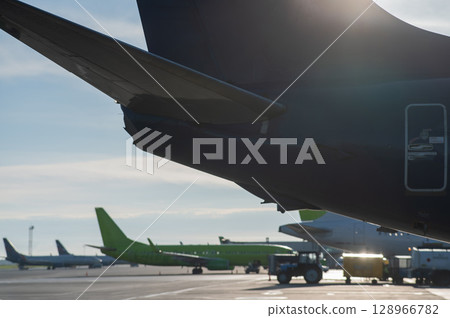 Airplane undergoing repairs in the open air. 128966782
