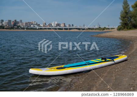 SUP board on a sandy beach. Summer sport. 128966869