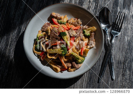 Pasta with beef, mushrooms and vegetables. Pasta with beef, mushrooms and vegetables. 128966870