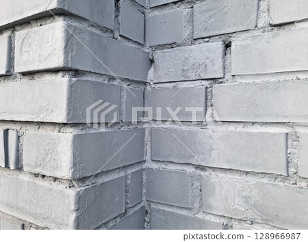 Corner of a gray brick wall texture with rough surface. 128966987