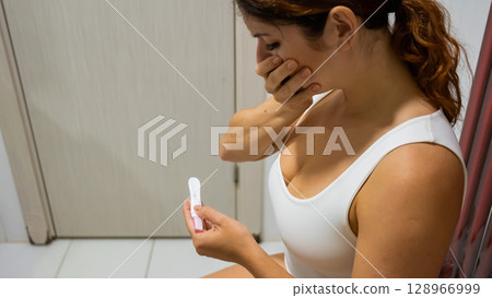 Woman upset by pregnancy test result. Woman upset by pregnancy test result. 128966999