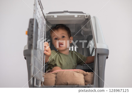 A small child in a closed cage. 128967125