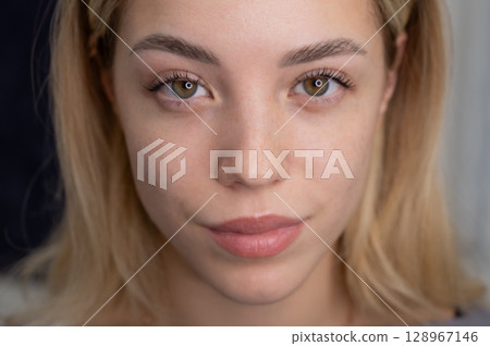 Close-up portrait of a woman after eyelash lamination procedure.  128967146