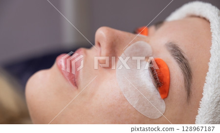 Caucasian woman undergoing eyelash lamination procedure.  128967187