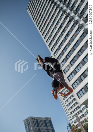 A girl jumps on a gymnastic trampoline. 128967365
