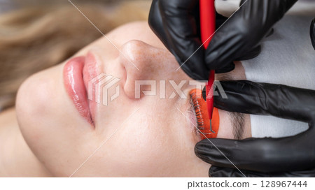 Caucasian woman undergoing eyelash lamination procedure.  128967444