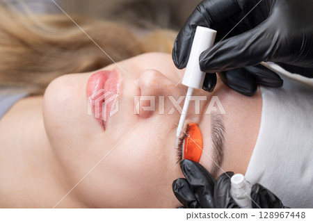 Caucasian woman undergoing eyelash lamination procedure.  128967448