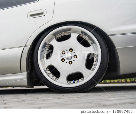 Close-Up of Custom Car Wheel and Tire Excellence. Close-Up of Custom Car Wheel and Tire Excellence. 128967493