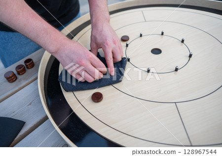 Strategic Game Pieces on a Wooden Board crokinole. Strategic Game Pieces on a Wooden Board crokinole. 128967544