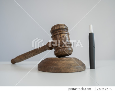Judge's gavel and electronic cigarette. Tobacco heating system.  128967620