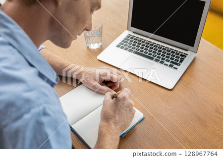 Young smiling man in a cafe having a video call Young smiling man in a cafe having a video call 128967764