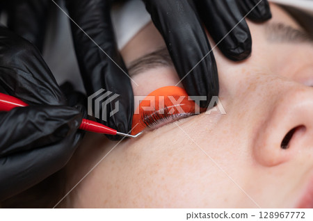 Caucasian woman undergoing eyelash lamination procedure. Caucasian woman undergoing eyelash lamination procedure. 128967772