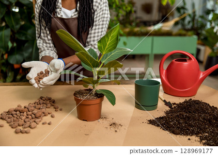 Close up of females hand holding soil for planting the flowers Close up of females hand holding soil for planting the flowers 128969177