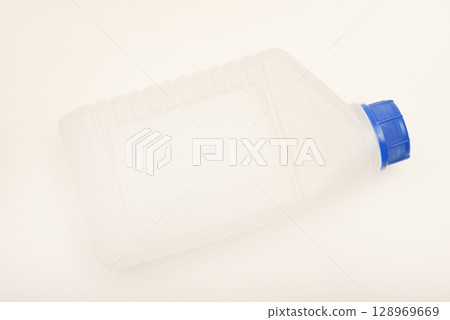 A white plastic container with a blue lid. A small plastic canister. A container with liquid. A white plastic container with a blue lid. A small plastic canister. A container with liquid. 128969669